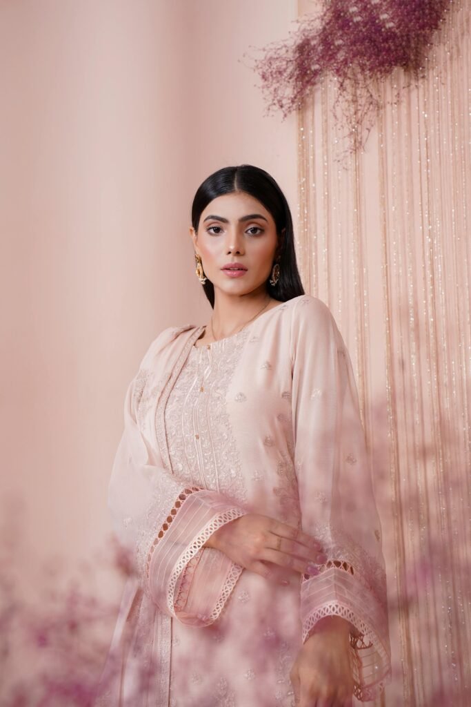 Portrait of a young woman in an elegant embroidered dress, exuding beauty and sophistication.